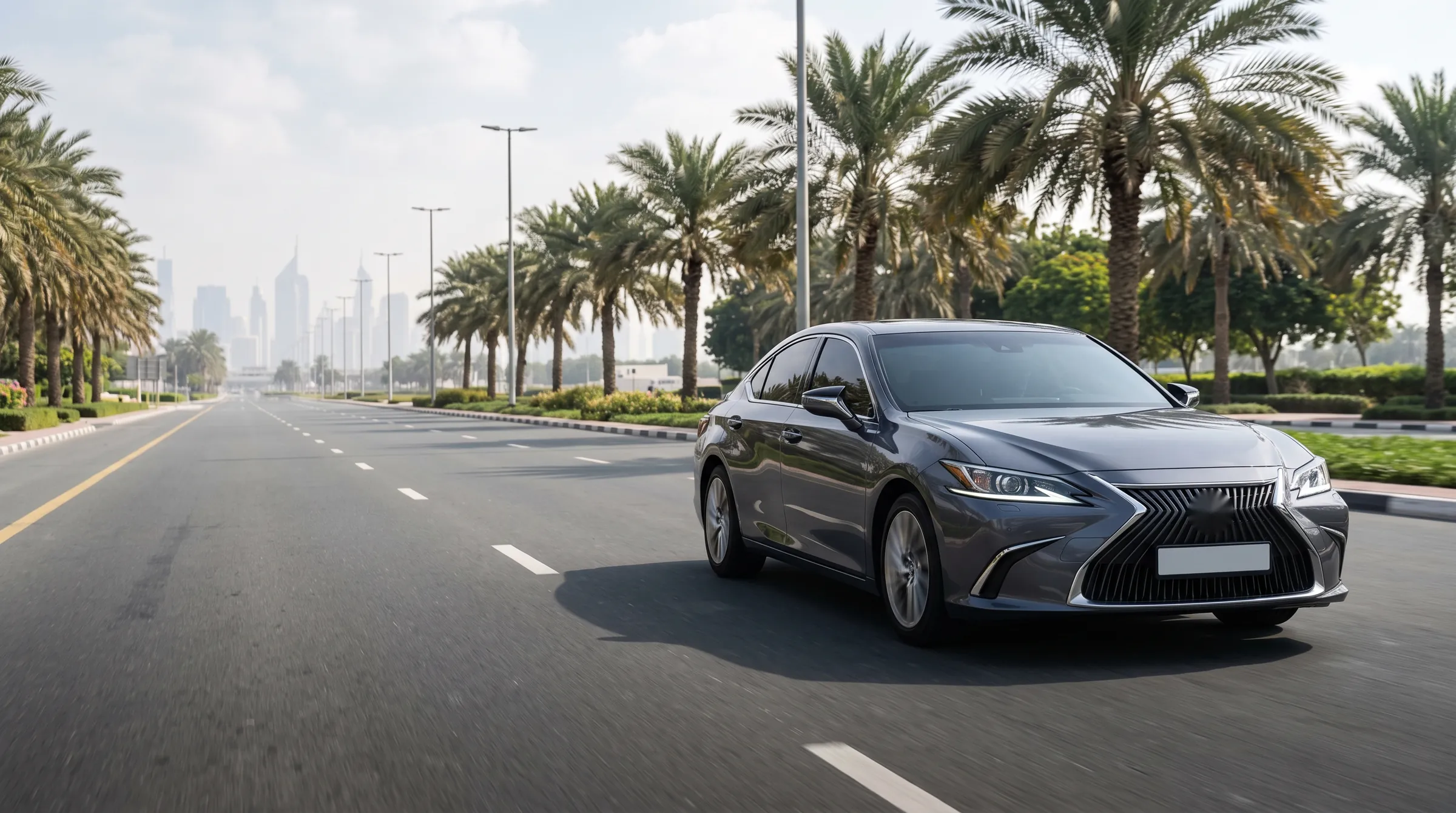 Executive sedan driving along a palm-lined Dubai boulevard